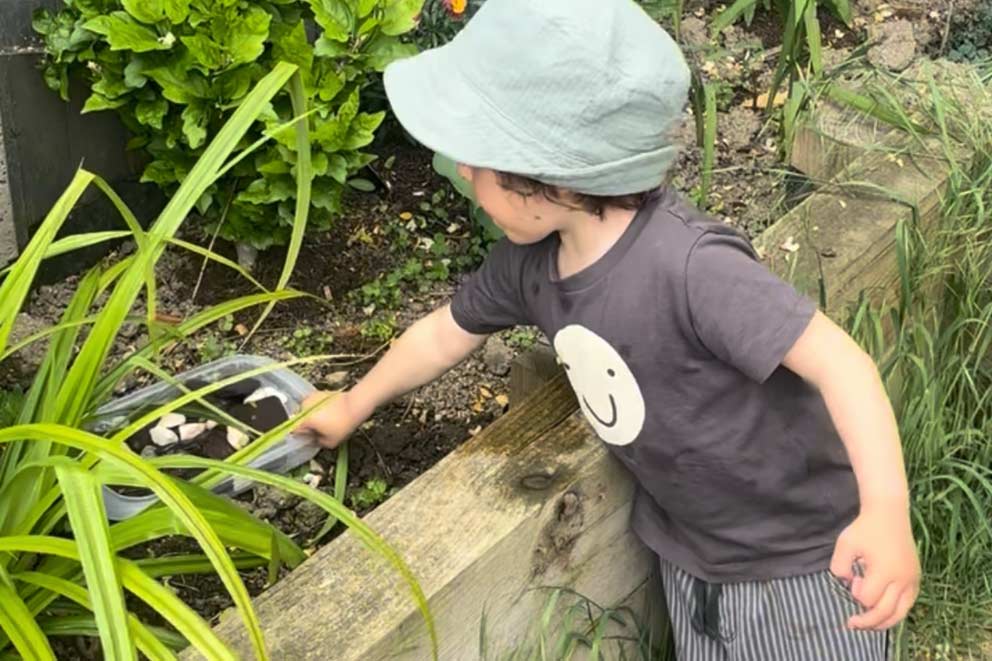 Jude admiring the new water station placed in a garden border.
